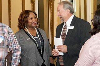 President Tracy D. Hall chats with Assistant Professor of English David Huffman, one of the conference coordinators.  