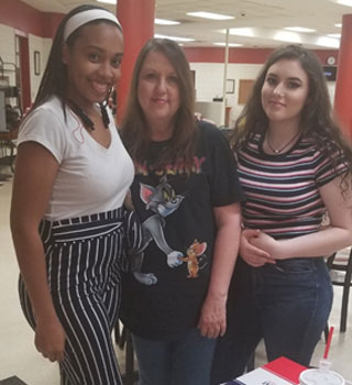 Mentor Lekeyantia Naylor (at left) meets her mentees at the D.R.E.A.M. Café Social on the Macon Cove Campus.