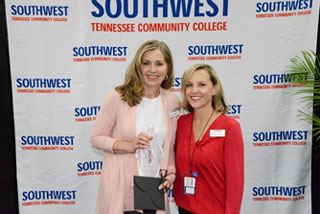 Special Assistant to the Vice President for Academic Affairs Sindy Abadie (right) presents Instructor and Academic Affairs newsletter editor Lane Roberts the Academic Affairs Vice President's Award for Excellence. 