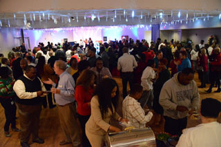 Faculty and staff mingle and enjoy a holiday buffet during the 2019 Holiday Open House.