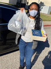 Early voter winner student Alicia Tucker picks up her swag bag and boxed lunch at the Union Avenue Campus after early voting. 