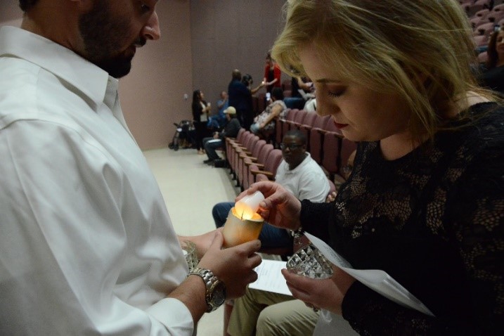 PTK inductees light each other’s candles signifying the light of knowledge. 