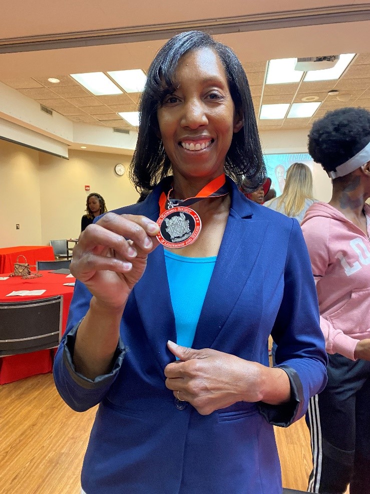 Vickie Maybank holds the NSLS medallion she received as a 2023 inductee. 