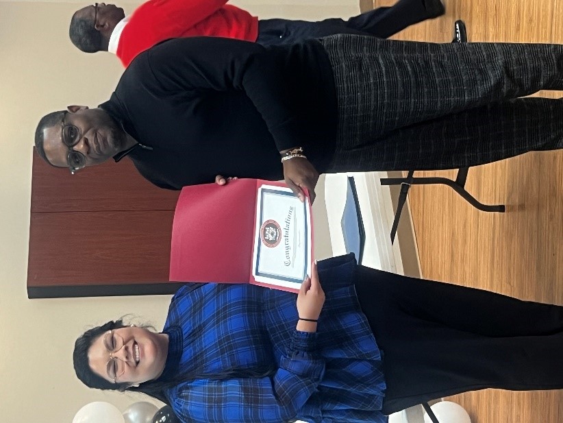 Dean of Students Alma Rutledge gives NSLS inductee Tony Dickerson his membership certificate. 