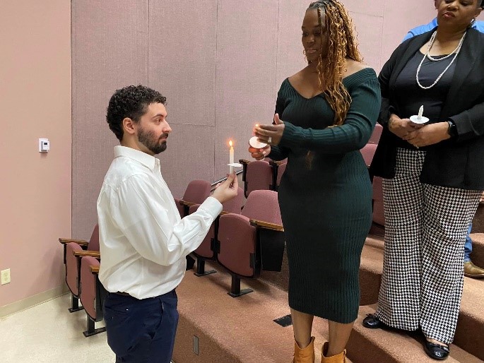 Upsilon Delta Chapter President Jason Friend initiates the candlelight ceremony during the chapter’s induction ceremony. 