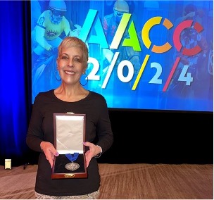 Rachel Trigg holds the Dale P. Parnell Distinguished Faculty Award she received at the 2024 AACC annual conference. 