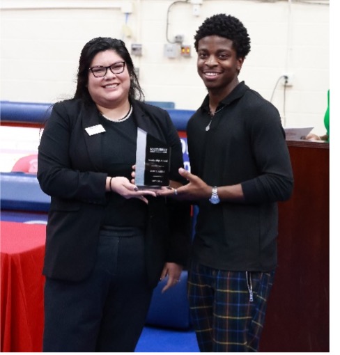 Samuel Harris receives the leadership award from Dean of Students Affairs Alma Rutledge.