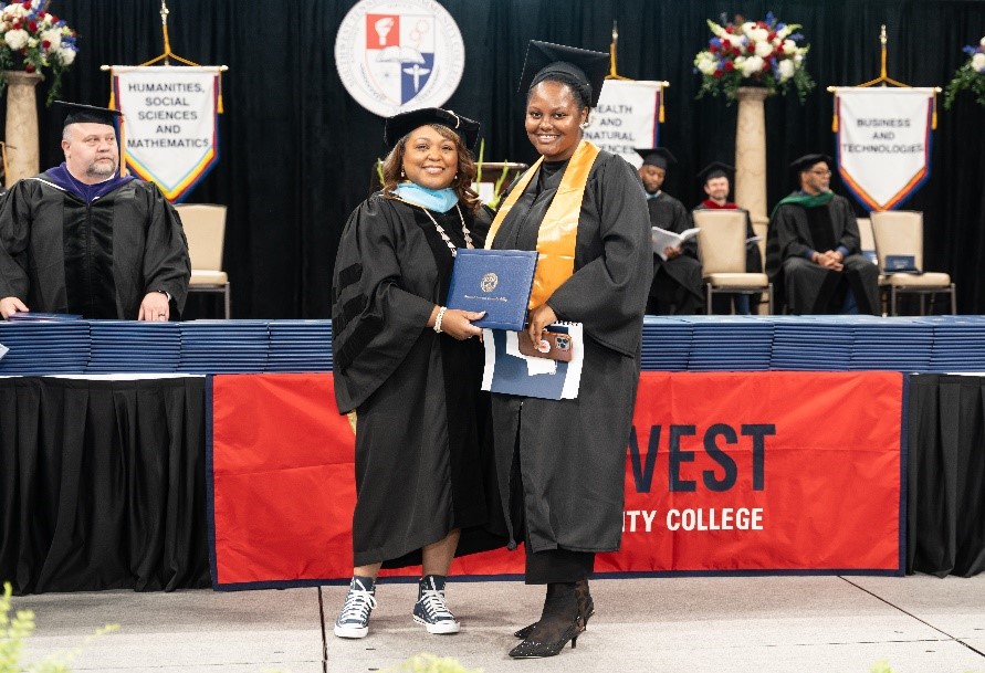 Nacaria Royal, the 2024 commencement speaker, receives her degree from Southwest president Tracy D. Hall. 