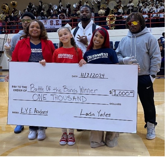 President Tracy D. Hall, Zamira Alexis and Ladia Yates award Craigmont High School as winners of the Battle of the Bands competition. 