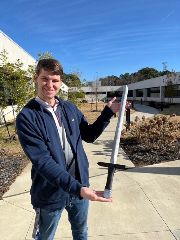 Joseph Lee displays his wooden model of the sword of Thrungva.