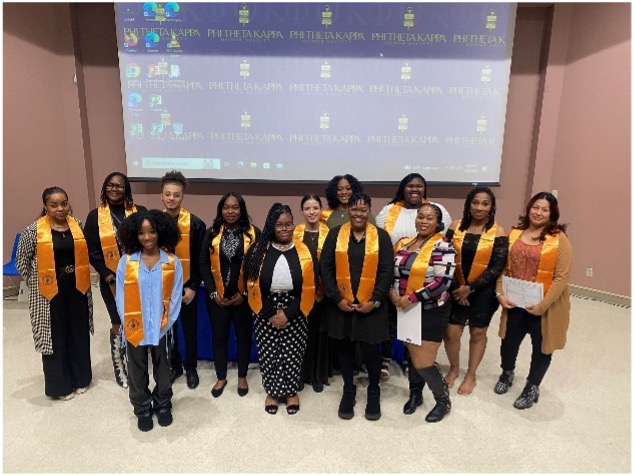 Members of the Upsilon Delta Chapter pose for a group photo during their induction ceremony.