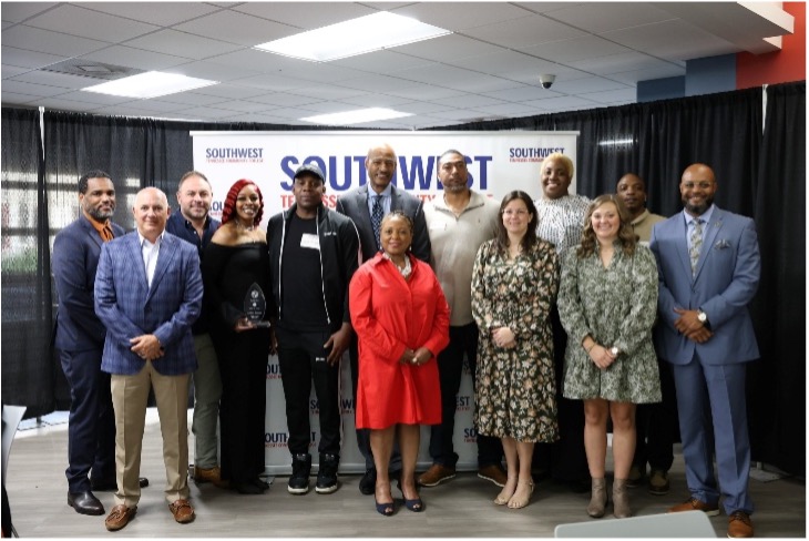 Dr. Hall standing with a dozen SWTCC retirees