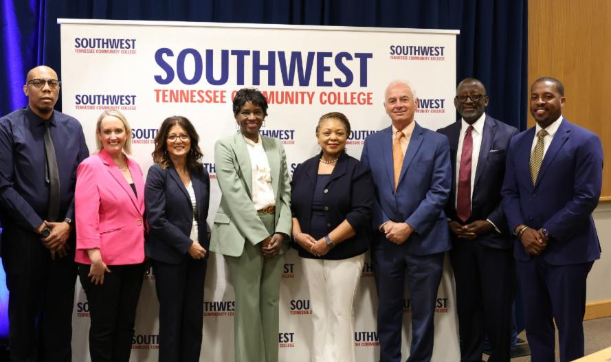 8 participants standing in front of the Southwest Tennessee Community College Banner