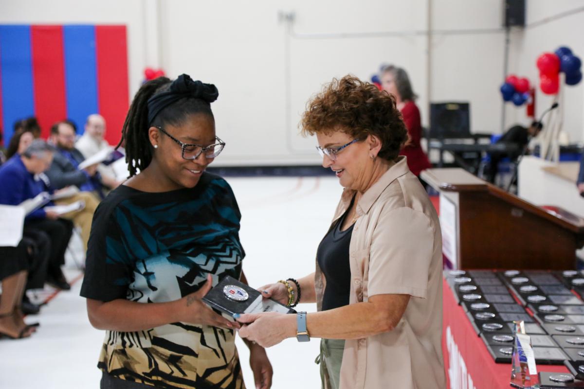Pharmacy Tech student Chelsea Smith receives an award from Merry Mattix, interim associate dean of Allied Health and Natural Sciences, during the 2026 Honors and Awards Convocation.
